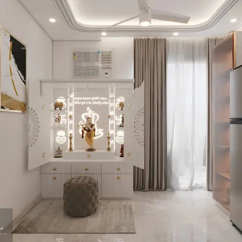 A backlit white pooja unit with jaali-cut doors and brass drawer pulls, set against a wall in a bedroom-adjacent nook.