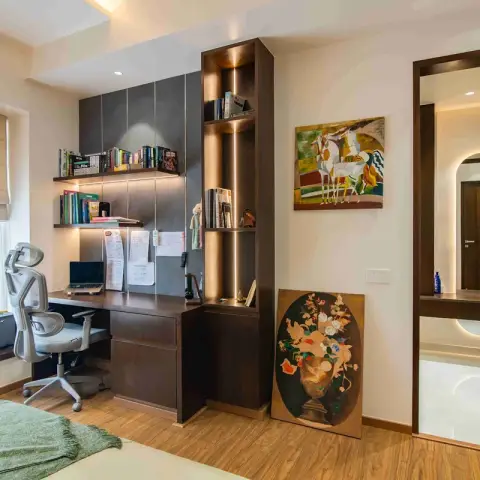A bedroom study corner in dark wenge joinery with LED-lit book shelves and a tall backlit display tower