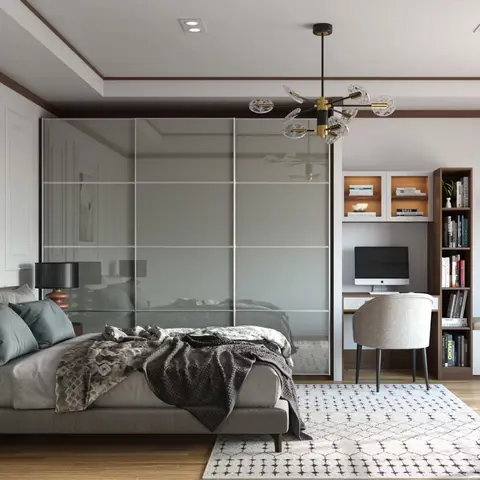 A bedroom with a smoked-mirror sliding wardrobe, a built-in study desk and bookshelf nook, and a cushioned window-seat bench
