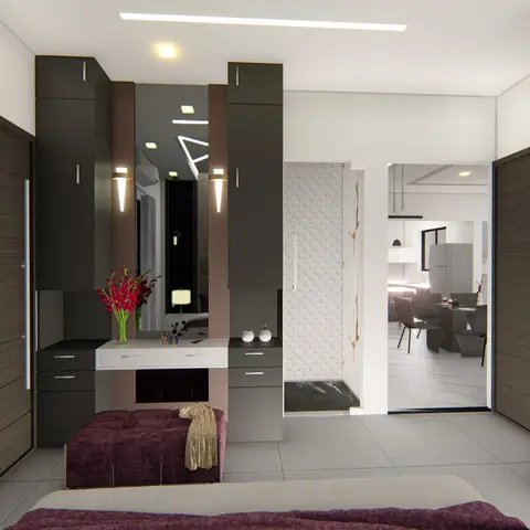 A bedroom with dark wood wardrobe walls flanking a mirrored dressing table, a maroon ottoman at the foot of the bed