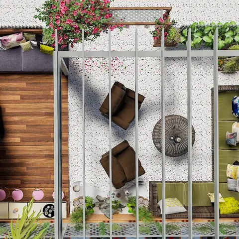 A bird's-eye view of a home terrace with a wood deck lounge area, rattan armchairs around a round coffee table