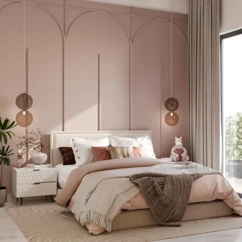 A blush-pink bedroom with triple arched wall panelling, twin globe pendant lights flanking an upholstered bed, and a plush toy on the pillows