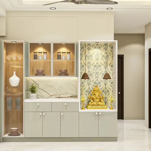 A built-in pooja niche with wallpapered temple-motif backdrop housing a brass Ganesh idol and hanging bells