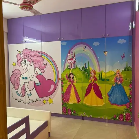 A children's bedroom with a purple wardrobe featuring unicorn and princess-themed printed shutters, a matching unicorn ceiling fan