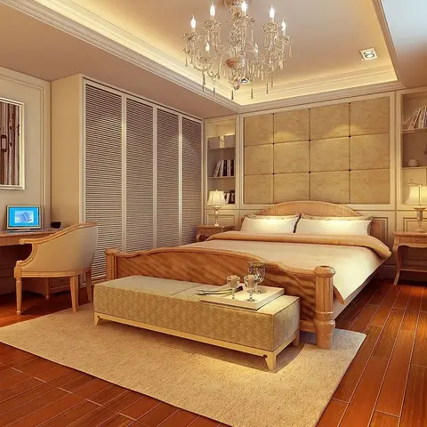 A classic-style bedroom with a tufted cream leather headboard wall, a crystal chandelier, louvred wardrobe doors, and a work desk with a laptop in the corner.