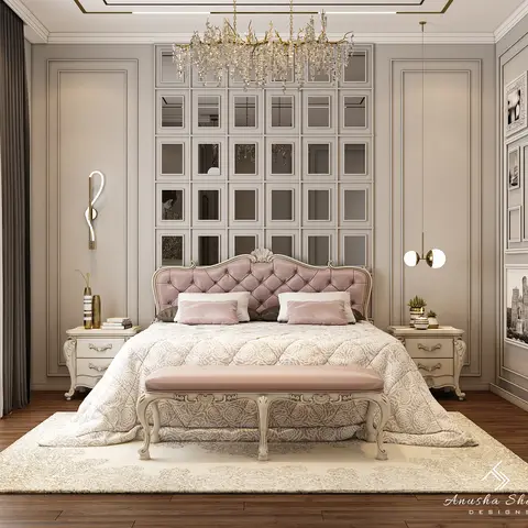 A classic-style bedroom with a blush tufted headboard bed and matching bench, a mirrored panel wall topped by a crystal branch chandelier