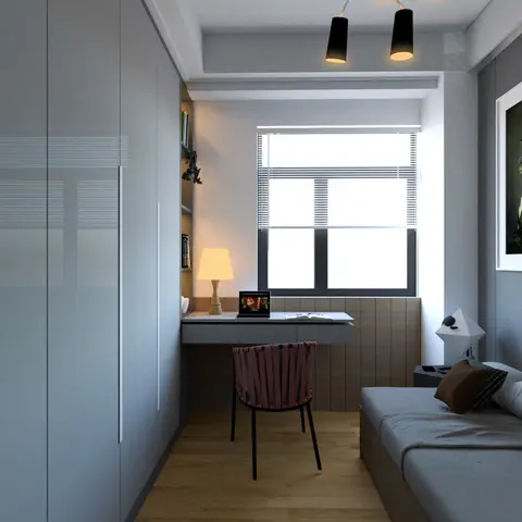 A compact study nook with a floating grey desk under a window, open wall shelving with books, a pink woven-strap chair