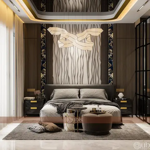 A dark upholstered king bed sits beneath a sculptural ribbon pendant light against a wavy wood-panel and floral-wallpaper feature wall in a moody