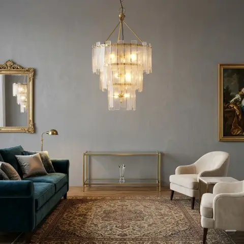 A deep teal velvet sofa and cream armchairs surround a Persian rug beneath a tiered glass chandelier