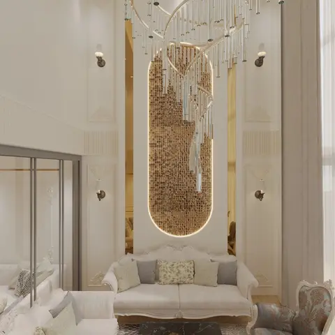 A double-height living room with an ornate carved sofa set, classical wall moulding, a gold mosaic-tiled feature niche