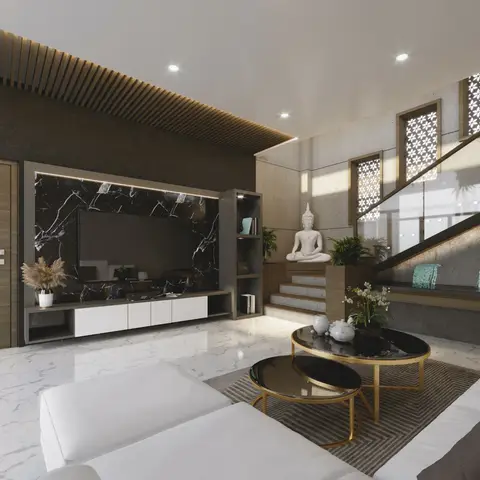 A double-height living room with a black marble TV feature wall, jaali-patterned windows beside the staircase, a seated Buddha statue