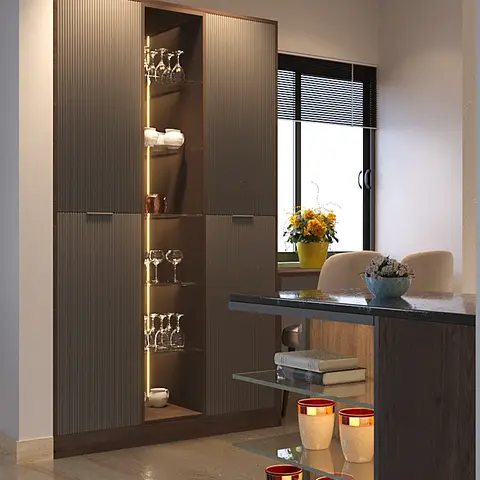 A fluted dark-wood crockery unit with a backlit glass display niche beside an open-shelf breakfast counter styled with crockery and glassware.