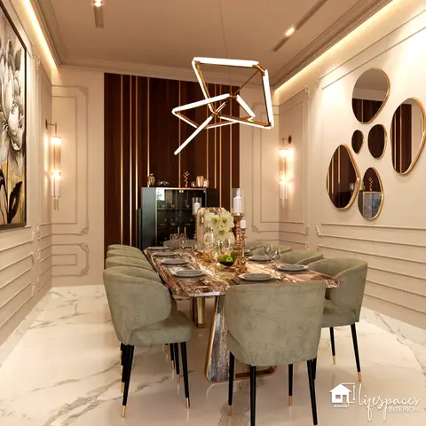 A formal dining room with a marble-top table, sage-green velvet chairs, a cluster of asymmetric mirrors on one wall, and a geometric gold pendant chandelier.