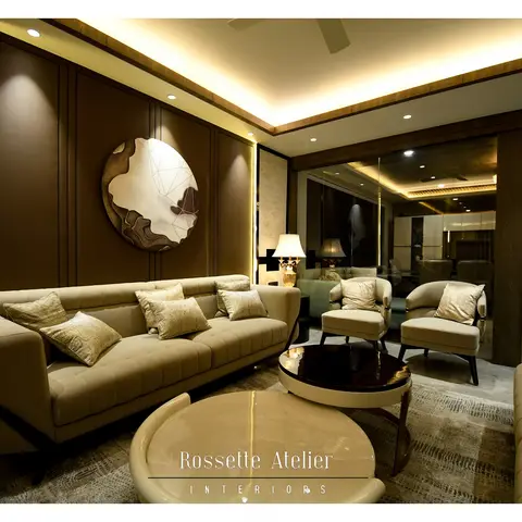 A formal living room with a dark brown leather-panelled feature wall holding a round abstract art piece