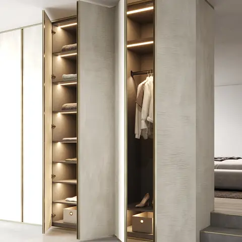 A freestanding wood-veneer wardrobe with backlit shelving and a hanging rail, set beside a raised bed platform in a primary bedroom.
