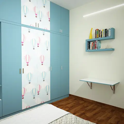A kids' bedroom with a sky-blue wardrobe featuring hot-air-balloon print center panels, a wall-mounted blue bookshelf, and a matching floating desk.