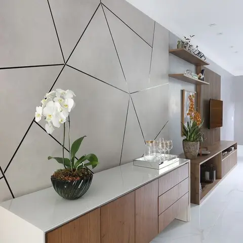 A living-room console wall with a geometric black-line inlay feature panel, a walnut sideboard styled with an orchid and drinks tray