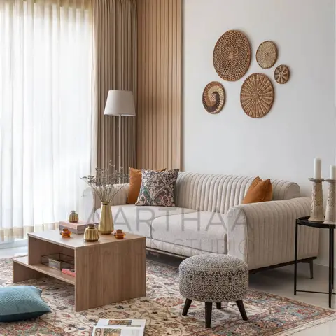 A living room corner with a fluted wood panel wall, a curated cluster of woven rattan wall plates