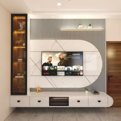 A living room TV feature wall with a marble-clad capsule panel set into fluted wall panelling, a floating white TV console