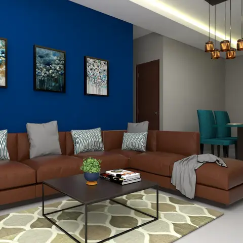 A living room with a bold blue accent wall hung with three framed floral artworks, a tan leather sectional sofa around a black coffee table on a patterned rug