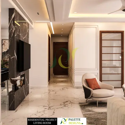 A living room with a book-matched black marble TV feature wall opposite cream leather armchairs, marble flooring