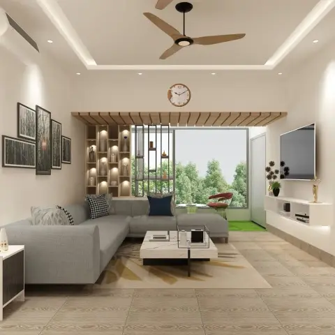 A living room with a grey L-shaped sectional sofa, a marble-top coffee table on a printed rug, a gallery wall of framed prints