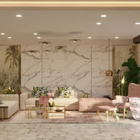 A living room with a large veined-marble slab feature wall behind a cream L-sofa with tropical-print cushions and a blush pink wingback chair