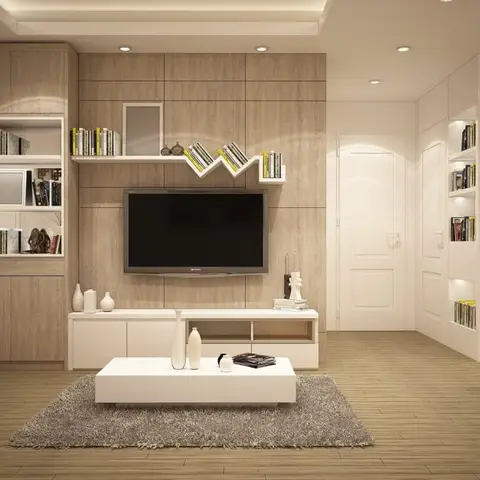 A living room with a wood-panelled TV wall, a zigzag floating bookshelf, and a white lacquer TV console flanked by a built-in bookshelf tower.
