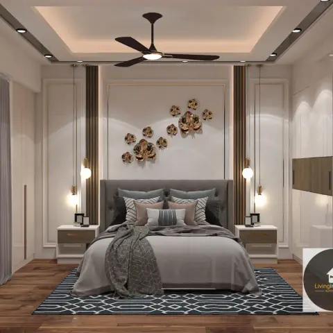 A master bedroom with a grey tufted upholstered bed beneath a gold 3D floral wall sculpture, flanked by hanging bulb pendant lights