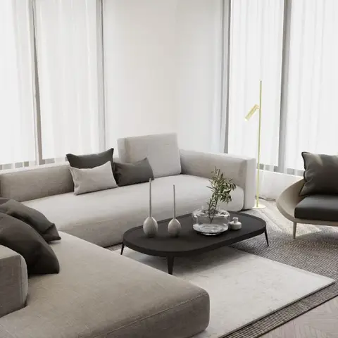 A minimalist living room with a large taupe L-shaped sectional sofa and a curved leather armchair around an oval black coffee table