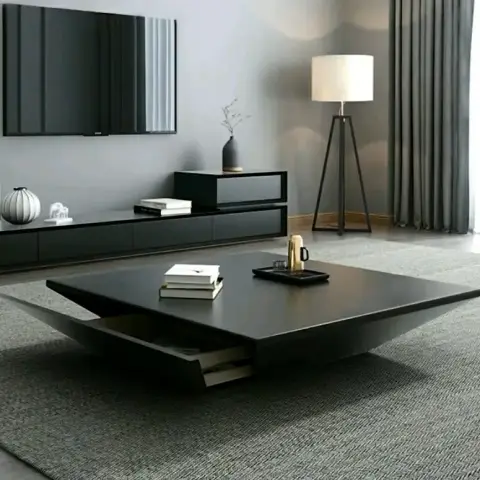 A monochrome living room with a low floating black TV console, a square black coffee table with a concealed pull-out drawer