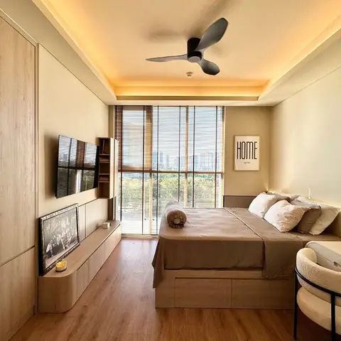 A pale oak bedroom against full-height glazing with timber venetian blinds: a storage bed with drawers in the base