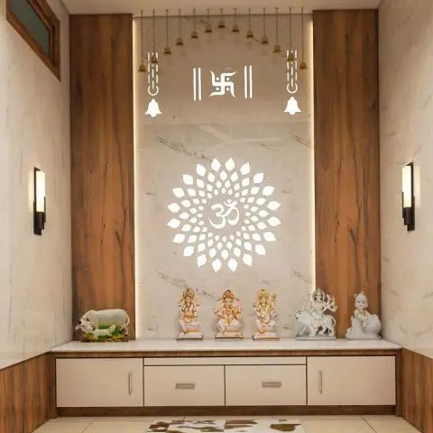 A pooja room with a backlit lotus-and-Om cutout motif on a marble panel, flanked by wood-clad walls, hanging brass temple bells