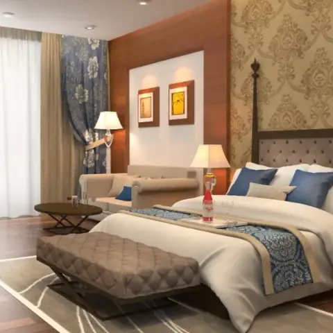 A render of a classic-styled bedroom with a four-poster tufted headboard bed against gold damask wallpaper, layered blue floral drapes