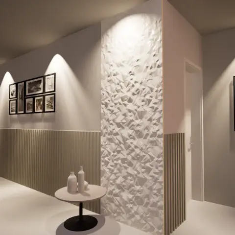 A render of a dining nook with carved wood dining chairs beside a gallery wall of framed photos and a faceted 3D textured feature wall leading to a hallway.