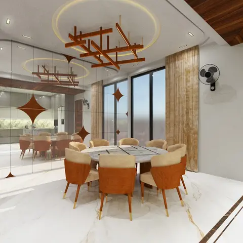 A round marble dining table with tan and rust upholstered chairs sits beneath a sculptural wood-and-brass beam chandelier