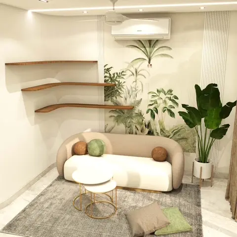 A small living room corner with a curved beige sofa, floating wood corner shelves, and a botanical jungle-mural wallpaper wall behind a large potted plant.