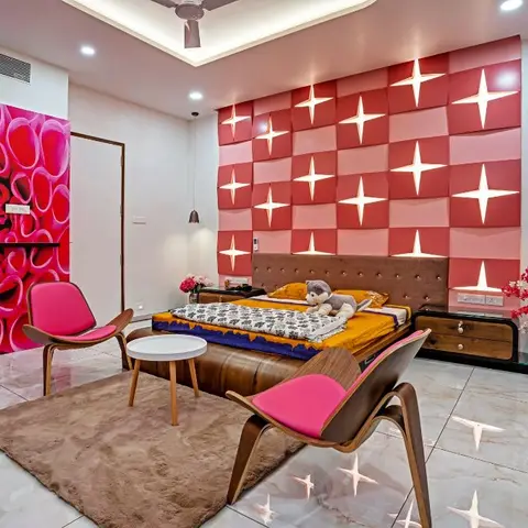 A vividly styled bedroom with a 3D pink-and-red star-patterned upholstered wall panel behind a brown tufted bed with mustard bedding and a teddy bear