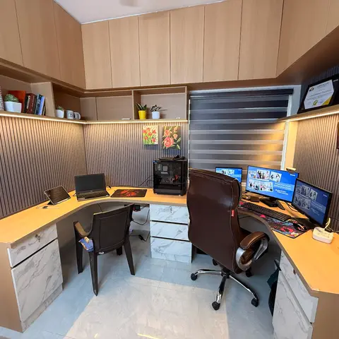 A wraparound built-in home-office desk with marble-look drawer fronts and fluted wood panelling