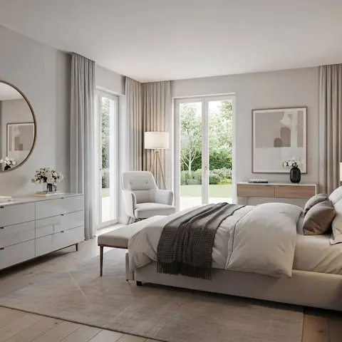 Airy master bedroom with an upholstered bed against a wood-panelled wall, a round mirror over a long six-drawer dresser