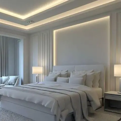 All-greige bedroom render with a double-stepped LED cove ceiling, a backlit recess framing the upholstered headboard
