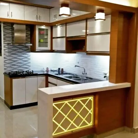 An L-shaped kitchen with wave-textured white backsplash tiles and white-and-wood cabinetry