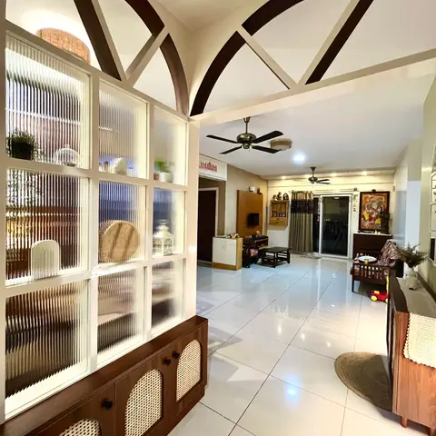An open-plan home viewed through an arched fluted-glass display cabinet, with an arched wood-beam ceiling leading into a living and dining area beyond.