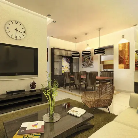An open-plan living-dining space with a wall-mounted TV, shaggy olive rug, rattan accent chair, and a dining table lit by three drum pendants.