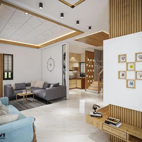 An open-plan render showing a grey-sectional living zone, a staircase, and a kitchen beyond