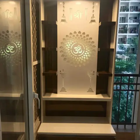 Backlit pooja unit with a CNC-cut Om medallion and Shree motif panel, open display shelves on either side, and storage drawers below.
