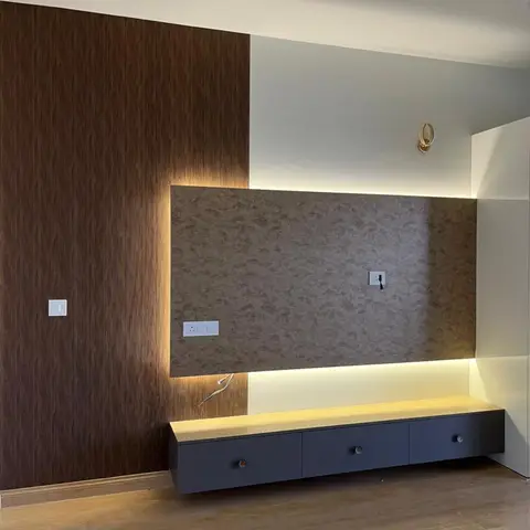 Backlit textured stone-look panel flanked by fluted wood wall cladding above a floating navy TV console with a wood top.