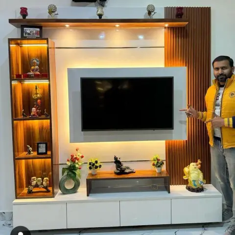 Backlit TV feature wall with a white-framed recess around the screen, a four-box LED-lit curio column in walnut laminate to the left