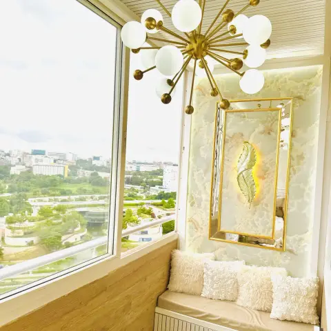 Balcony seating nook with a gold sputnik multi-globe chandelier, an onyx marble feature wall with a mirrored gold leaf art panel
