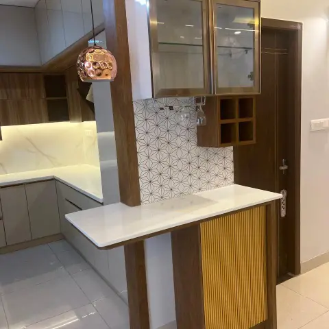 Bar counter built onto the kitchen entrance wall - white quartz top on a walnut frame with a mustard fluted front